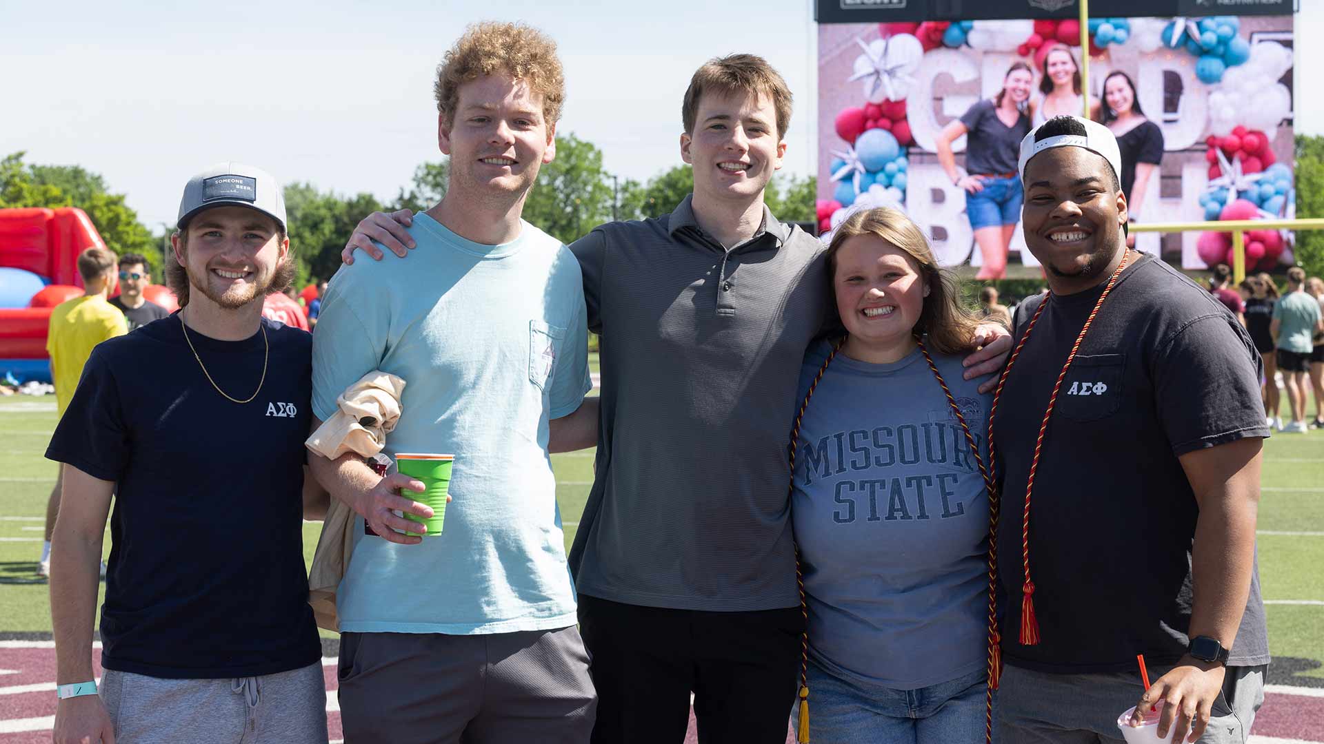Five soon-to-be BearGrads pose for a group photo at Grad Bash.