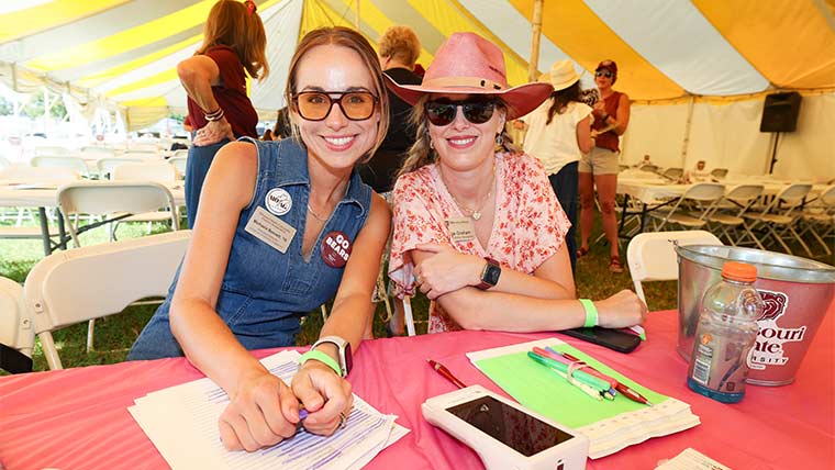 Alumni Association staff at a signup table at the state fair.