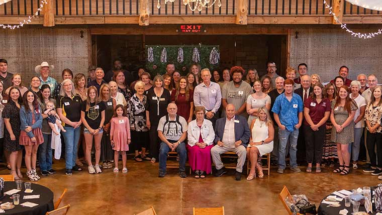 Several dozen attendees pose for a group photo at a Lebanon alumni chapter event.