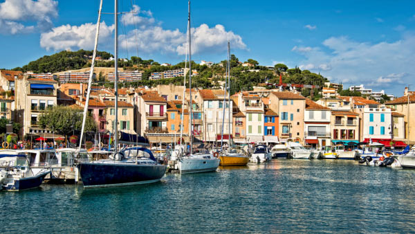 Boats and houses fill the cove in Provence, France.